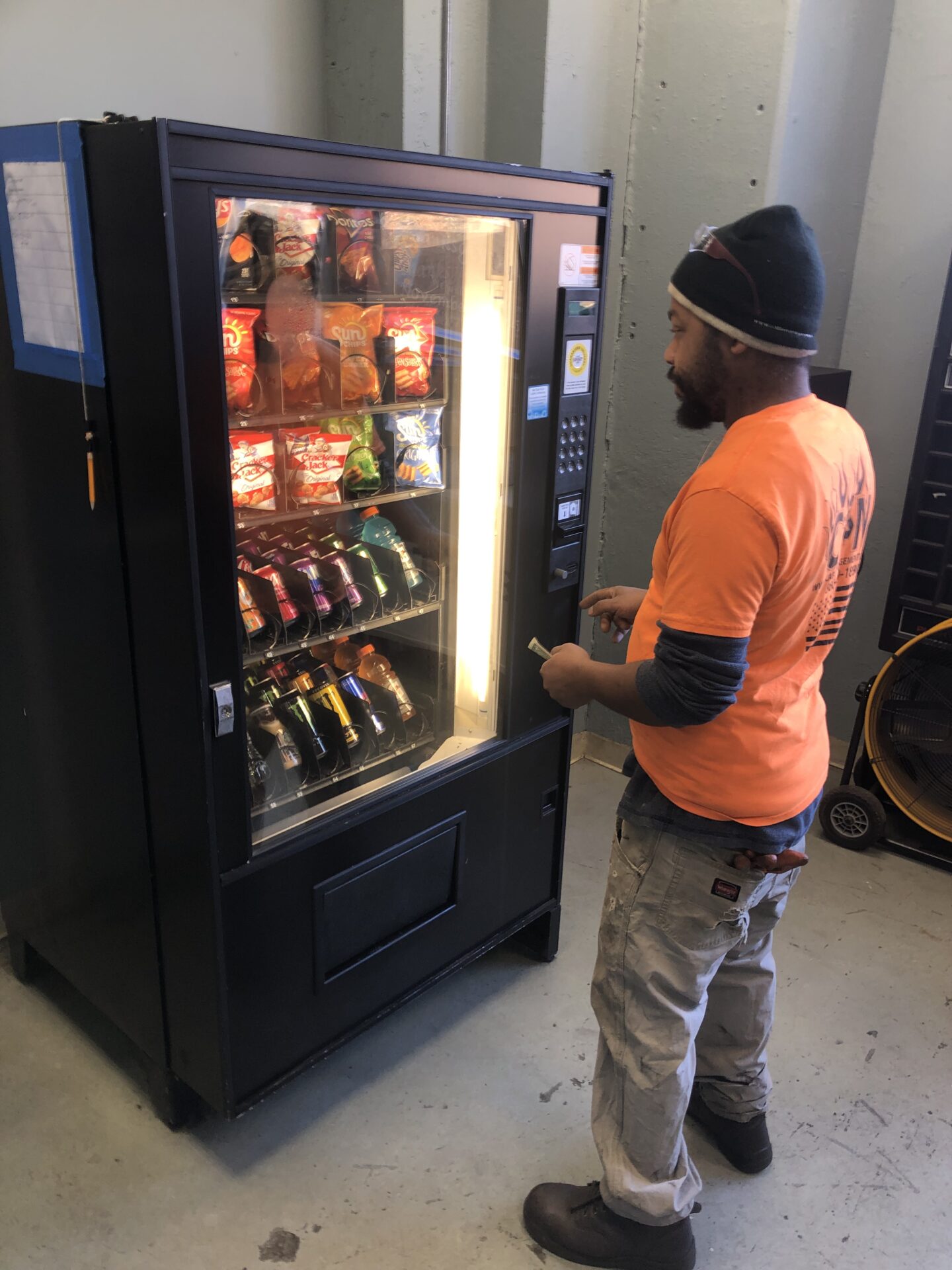 A Man Accessing The Vending machines A Man Accessing The Vending machines